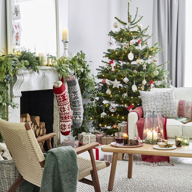 decorated living room with stockings and a christmas tree