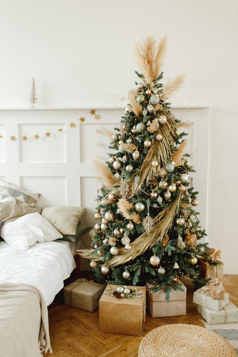 christmas tree with gifts, decorated with trinkets and garlands new year celebration concept