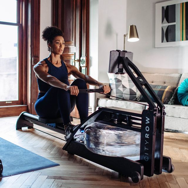 individual using a cityrow rowing machine in their living room