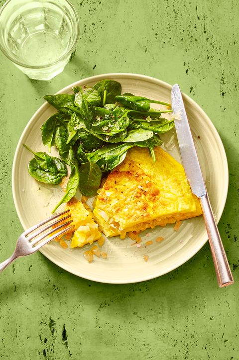 classic omelet and greens on a white plate