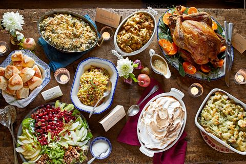 a classic thanksgiving table shot from overhead with a variety of dishes