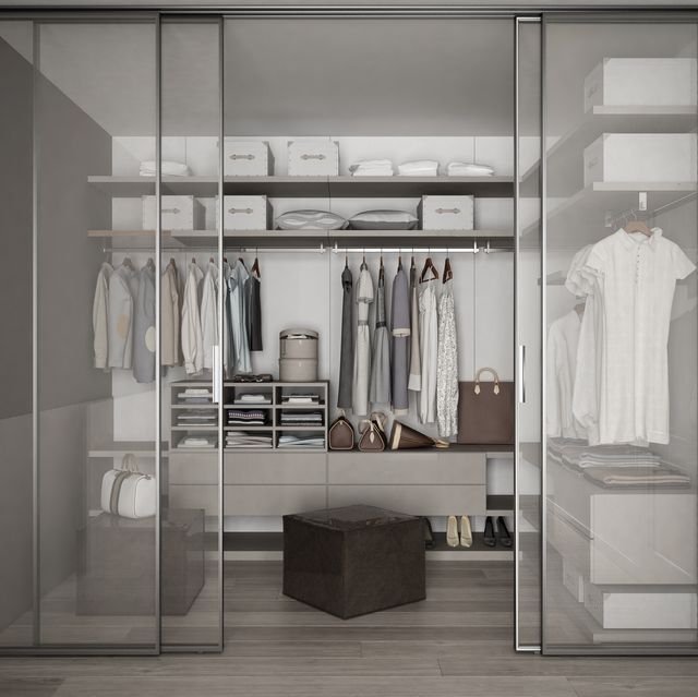 classic walk in closet with glass sliding doors