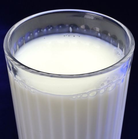 Clear serving glass of fat free milk (Bos primigenius)