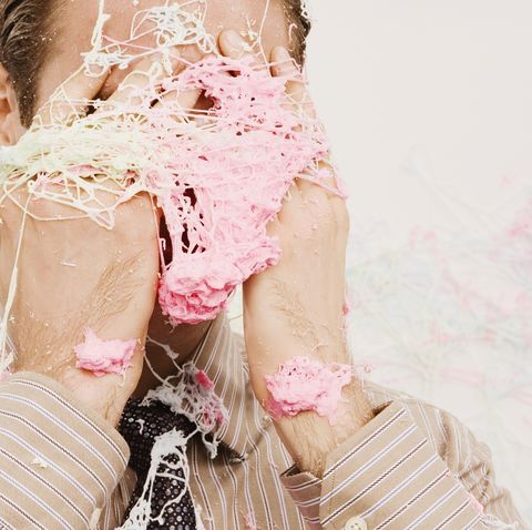 Close-up of a businessman covered with spray string