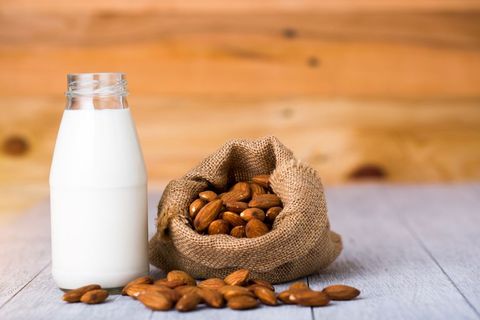 almonds and bottle of milk on table