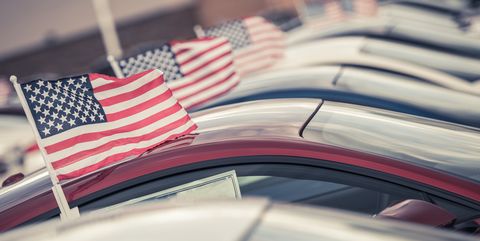 Close-Up Of American Flags On Cars