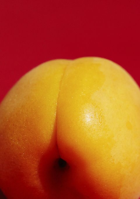 Close up of an apricot on a red background