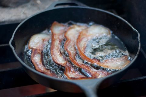 Close-Up Of Bacon Frying In Pan