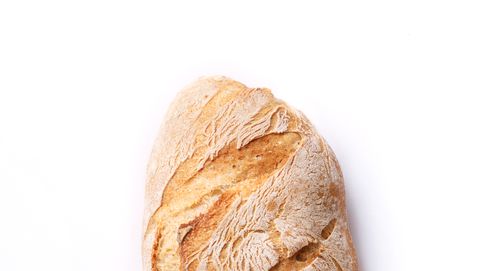 Close-Up Of Bread Against White Background