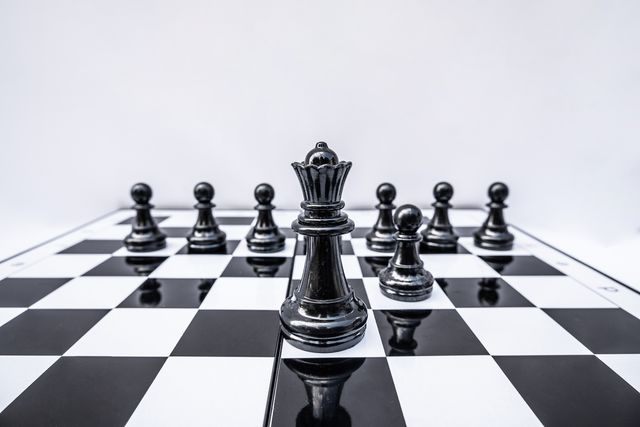 close up of chess board against white background