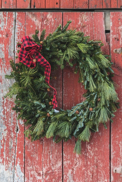 close up of christmas decoration hanging against red door