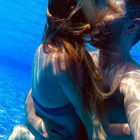 Close-Up Of Couple Kissing In Swimming Pool