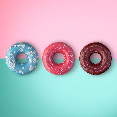 Close-Up Of Donuts Over Colored Background