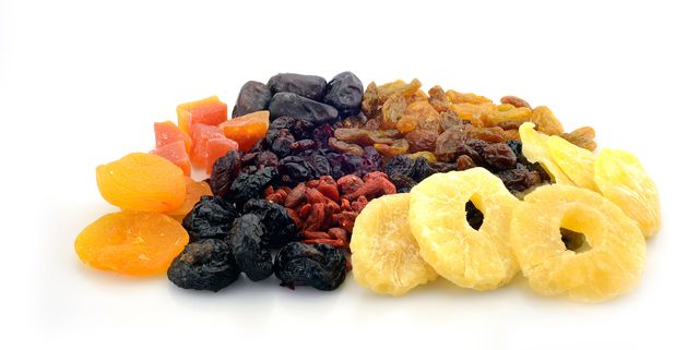 close up of dried fruits over white background
