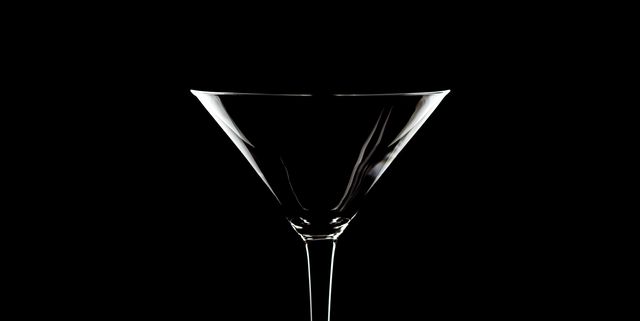 close up of drinking glass against black background