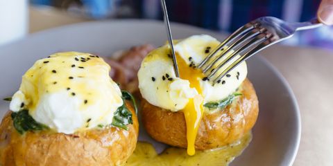 Close up of Eggs Benedict with liquid egg yolk running out