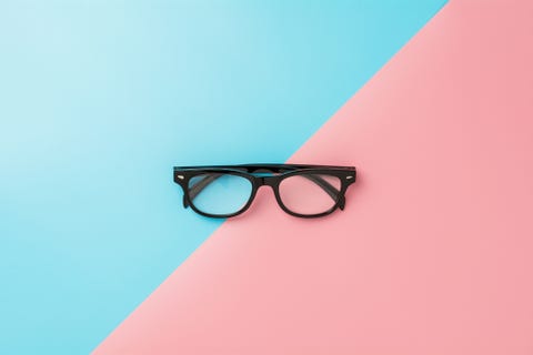 close up of eyeglasses on colored background