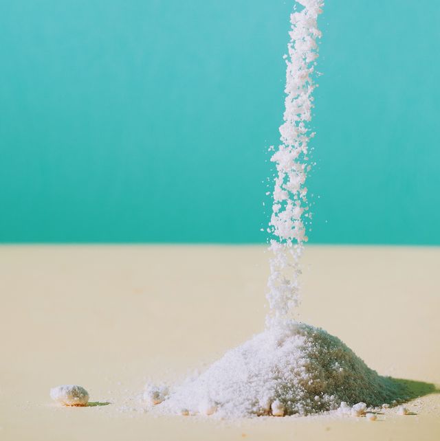 falling salt on surface against turquoise background