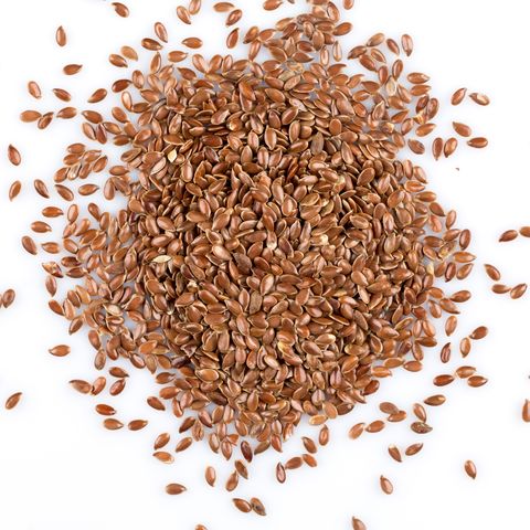 close up of flax seeds isolated on white background
