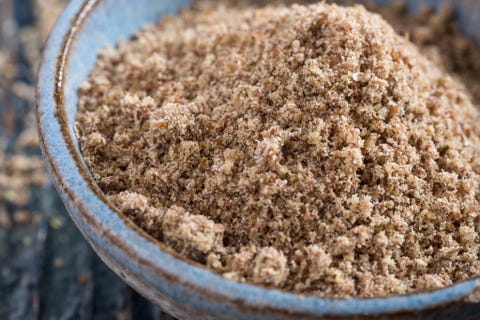 Grind flax seeds in a bowl on the table