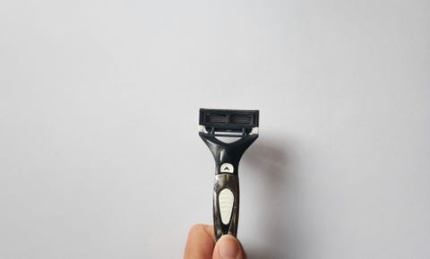 Close-Up Of Hand Holding Against White Background