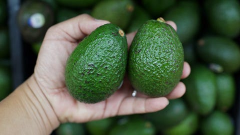 Close-Up Of Hand Holding Fruits
