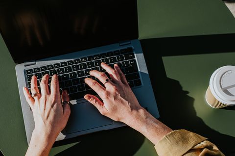 close up of hands typing on a laptop computer