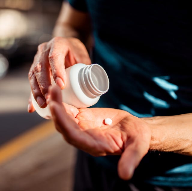 close up of human hands he is taking pill