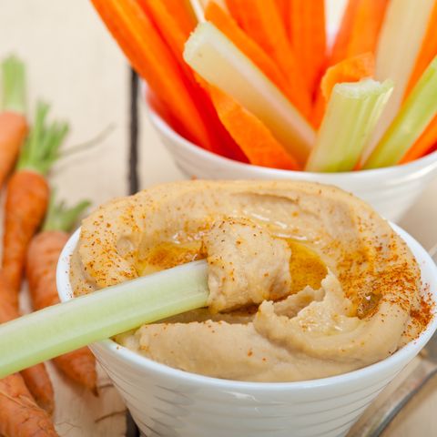 Close-Up Of Hummus And Root Vegetables On Table