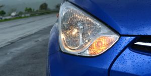 Close-Up Of Illuminated Car Headlight