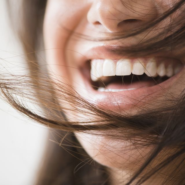 close up of laughing woman with messy hair