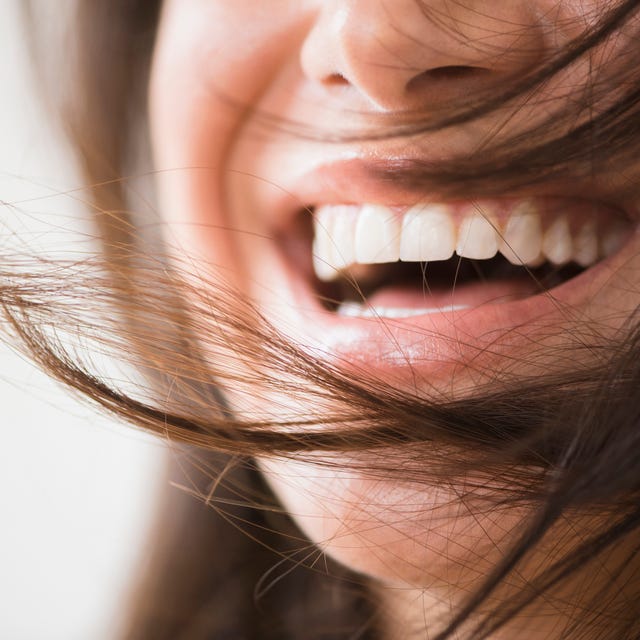 Close up of laughing woman with messy hair close up of laughing woman with messy hair