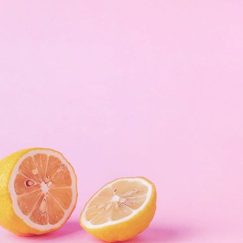 Close-Up Of Lemon Slices Against Pink Background