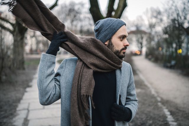 close up of man wearing scarf at park during winter