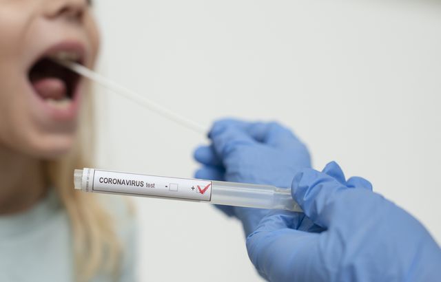 close up of nurses hands holding buccal cotton swab and test tube ready to collect coronarovirus test, covid 19, 2019 ncov analysis