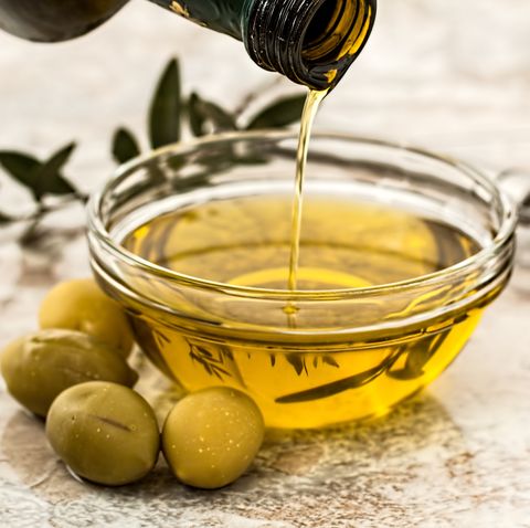 Close-Up Of Olive Oil On Table