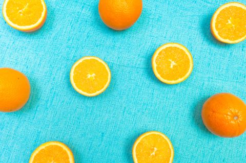 Close-Up Of Orange Fruits On Blue Table