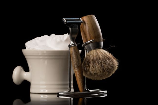 close up of shaving equipment against black background