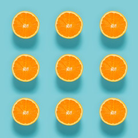 Close-Up Of Sliced Orange Fruits On Blue Background
