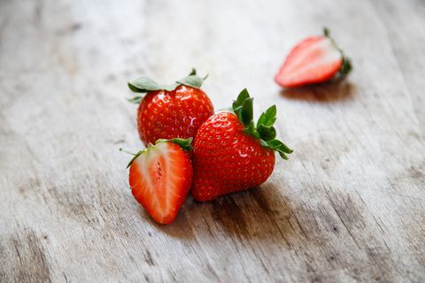 close up of strawberries on wooden table