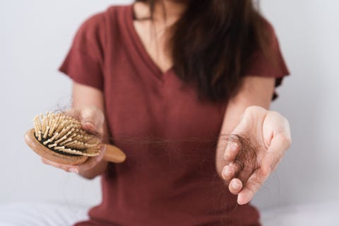 close-up-of-woman-holding-comb-and-hair-at-home-royalty-free-image-1663848763