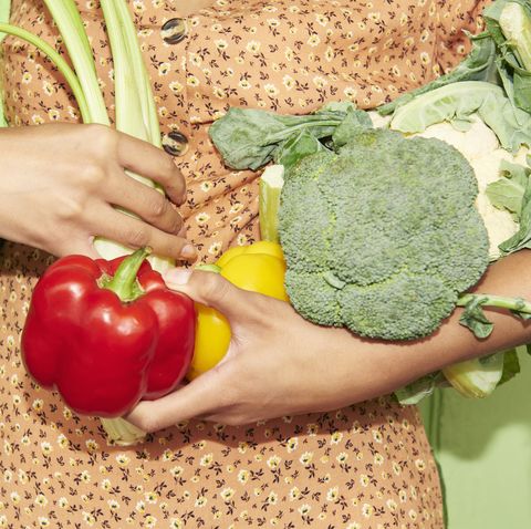 close up of woman holding vegetables