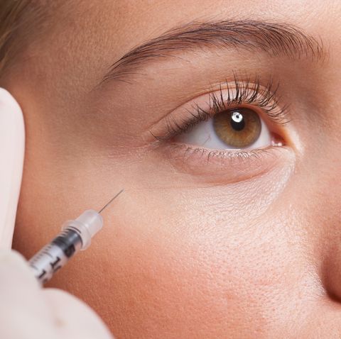Close up of woman receiving botox injection under eye