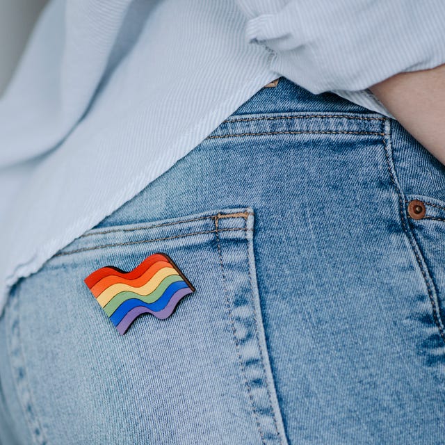 Close Up Of Woman Wearing Rainbow Badge close up of woman wearing rainbow badge