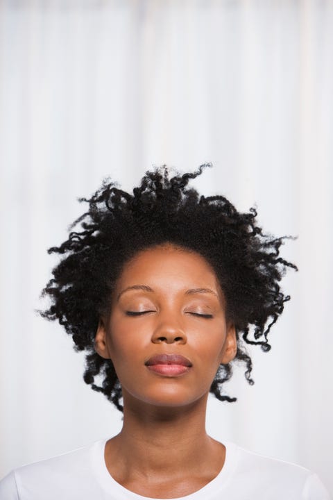 Close up of young African woman with eyes closed