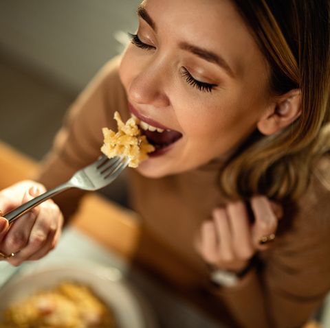 young happy woman eating