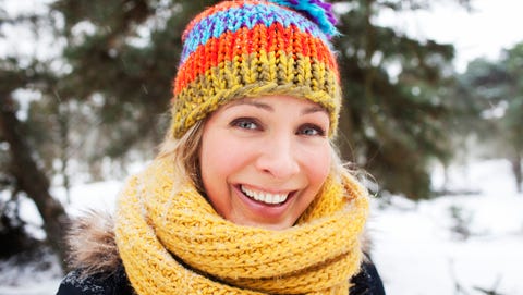 Close up portrait of woman in wooly hat and scarf in winter Close up portrait of woman in wooly hat and scarf in winter