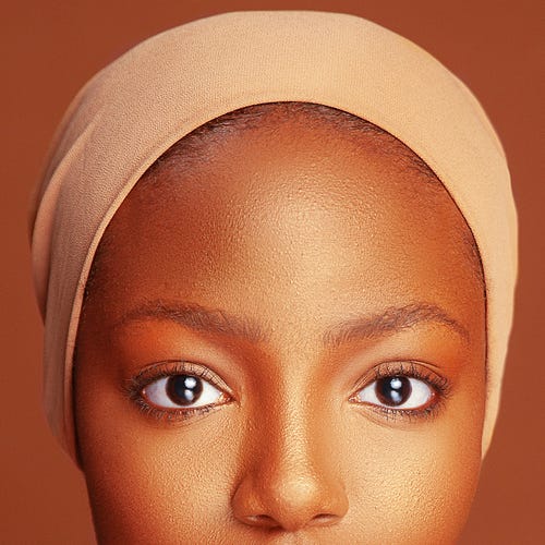 Close-Up Portrait Of Young Woman Wearing Headband Against Brown Background close up portrait of young woman wearing headband against brown background