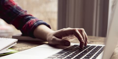 close up teenage girl using laptop computer