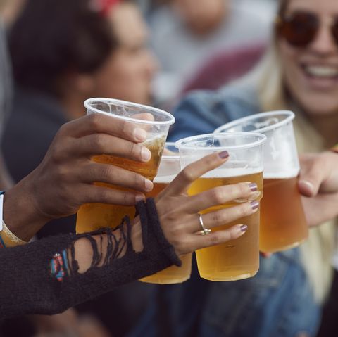 close up uf hands toasting in beer, at festival